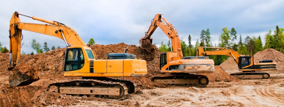 three excavator in line digging red sand